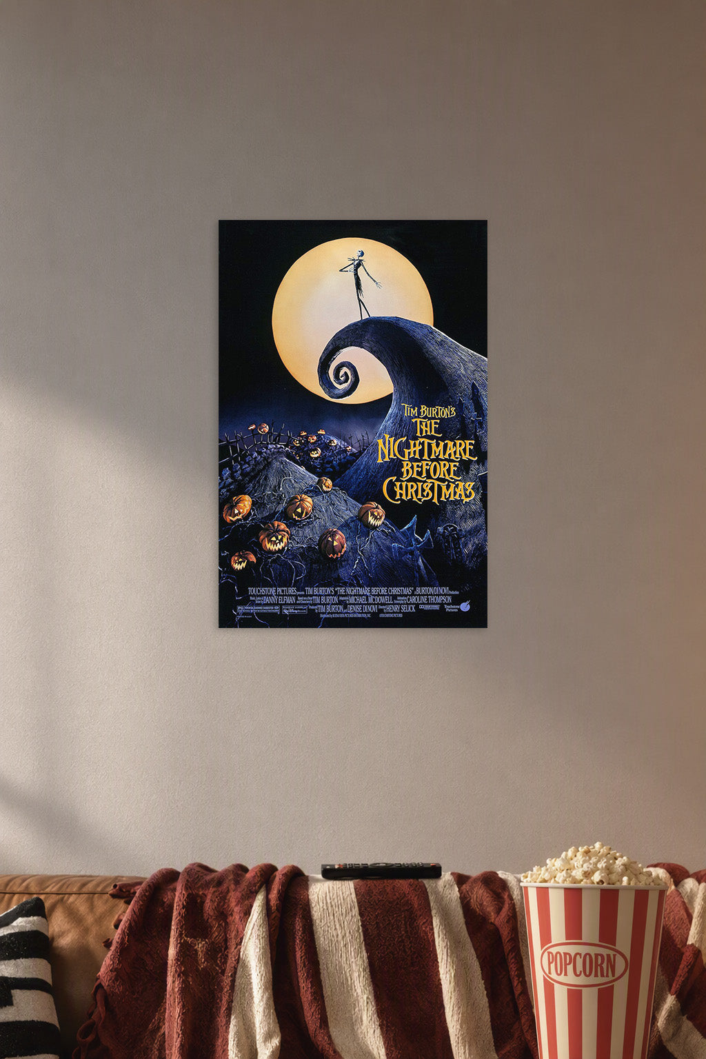 Tim Burton's The Nightmare Before Christmas in a cozy movie room above a brown sofa with popcorn.