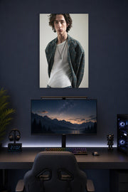 Timothée Chalamet in a gaming desk setup above a monitor.