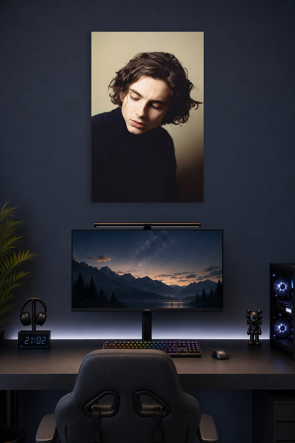 Timothée Chalamet in a gaming desk setup above a monitor.