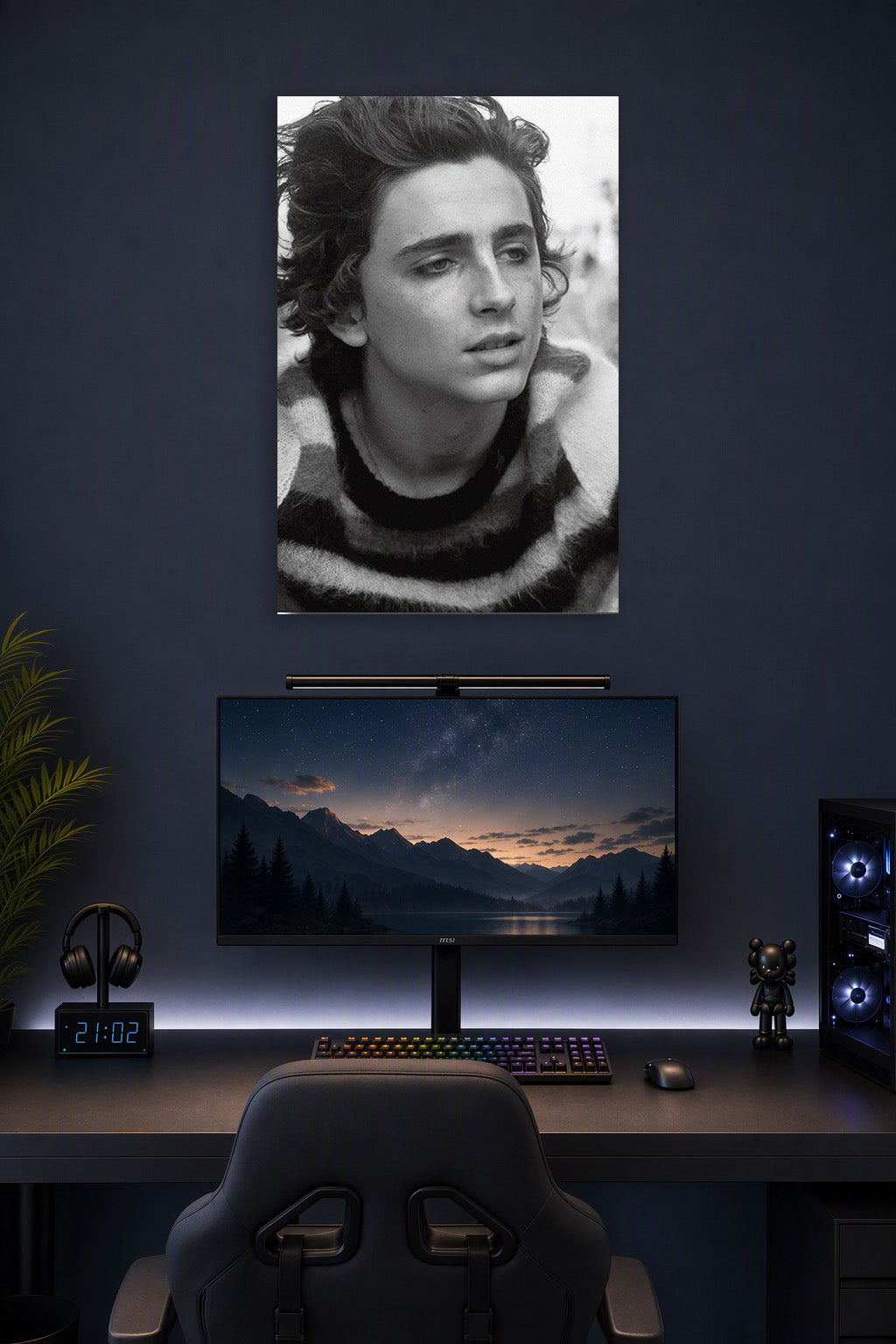 Timothée Chalamet in a gaming desk setup above a monitor.