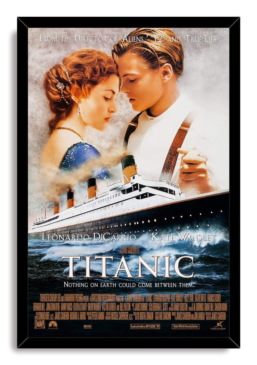 Titanic movie poster wall art print in a black frame, with Jack and Rose above the Titanic on rolling dark ocean waves.