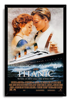 Titanic movie poster wall art print in a black frame, with Jack and Rose above the Titanic on rolling dark ocean waves.