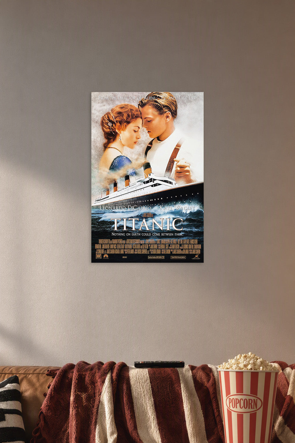 Titanic Movie Poster Jack and Rose in a cozy movie room above a brown sofa with popcorn.