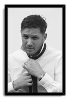 Tom Hardy framed wall art print with a black border, portraying him in a white shirt as he adjusts his dark tie.