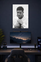 Tom Hardy in a gaming desk setup above a monitor.