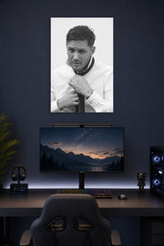 Tom Hardy in a gaming desk setup above a monitor.