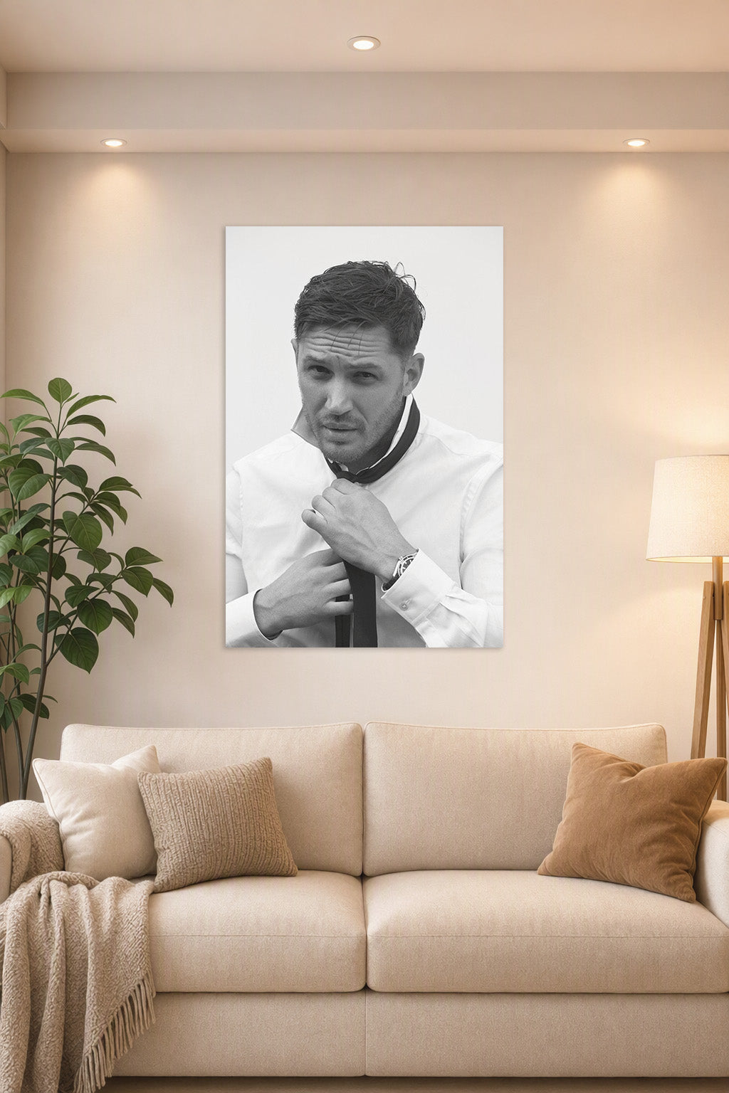 Tom Hardy in a bright living room above a beige sofa.