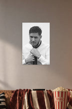 Tom Hardy in a cozy movie room above a brown sofa with popcorn.