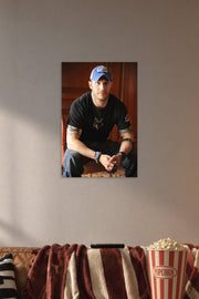 Tom Hardy in a cozy movie room above a brown sofa with popcorn.