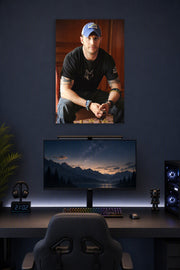 Tom Hardy in a gaming desk setup above a monitor.