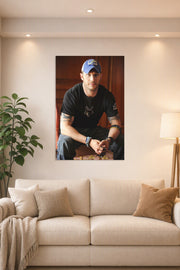 Tom Hardy in a bright living room above a beige sofa.