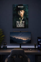 Tom Hardy Peaky Blinders in a gaming desk setup above a monitor.