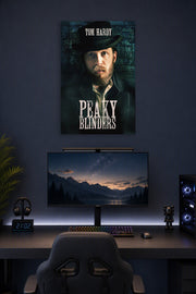 Tom Hardy Peaky Blinders in a gaming desk setup above a monitor.