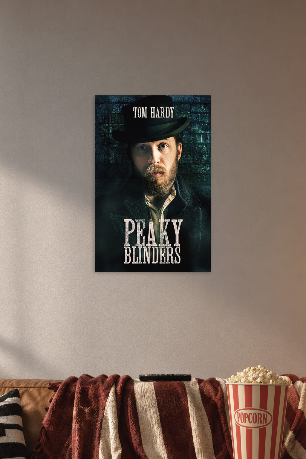 Tom Hardy Peaky Blinders in a cozy movie room above a brown sofa with popcorn.