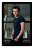 Tom Holland framed wall art print with a black border, portraying him in a navy shirt and watch before city windows.