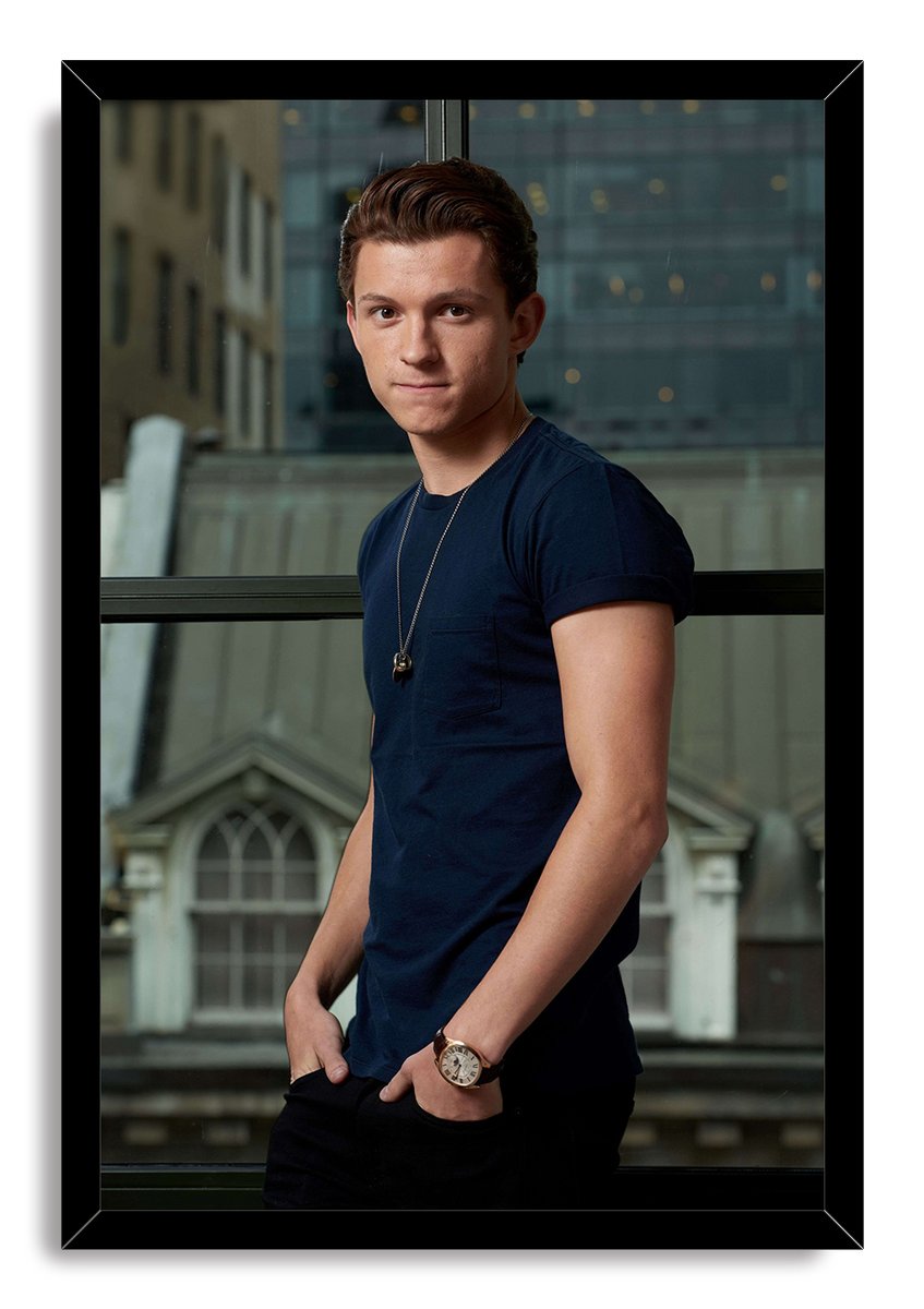 Tom Holland framed wall art print with a black border, depicting him in a navy shirt and watch before glass windows.