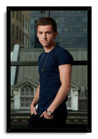 Tom Holland framed wall art print with a black border, depicting him in a navy shirt and watch before glass windows.