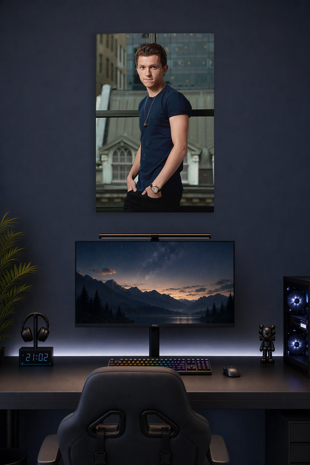 Tom Holland in a gaming desk setup above a monitor.