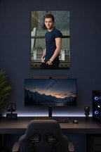 Tom Holland in a gaming desk setup above a monitor.