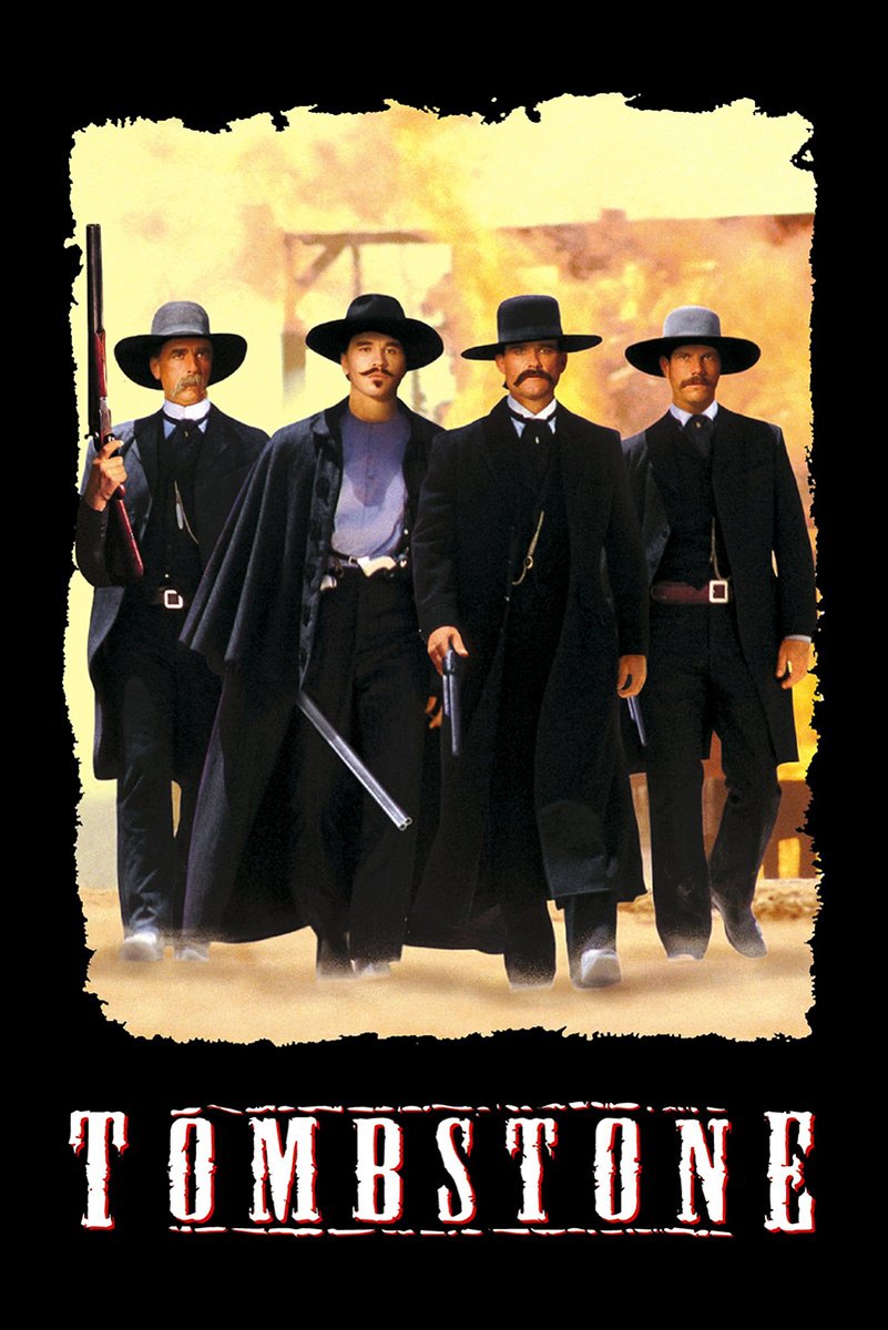 Tombstone wall art print features four Western men in black coats and wide-brim hats walking through dusty golden light.