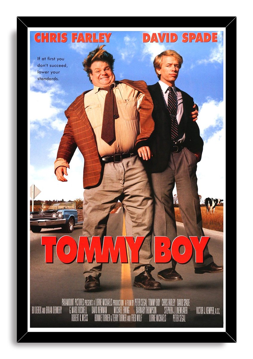 Tommy Boy framed wall art print with a black border, Chris Farley and David Spade standing on a road beneath a blue cloudy sky.