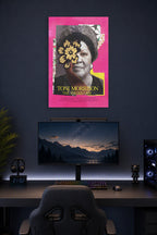 Toni Morrison in a gaming desk setup above a monitor.