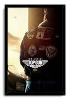 Top Gun Maverick framed wall art print presents Tom Cruise from behind in a patched bomber jacket, with sunset light and a distant aircraft.