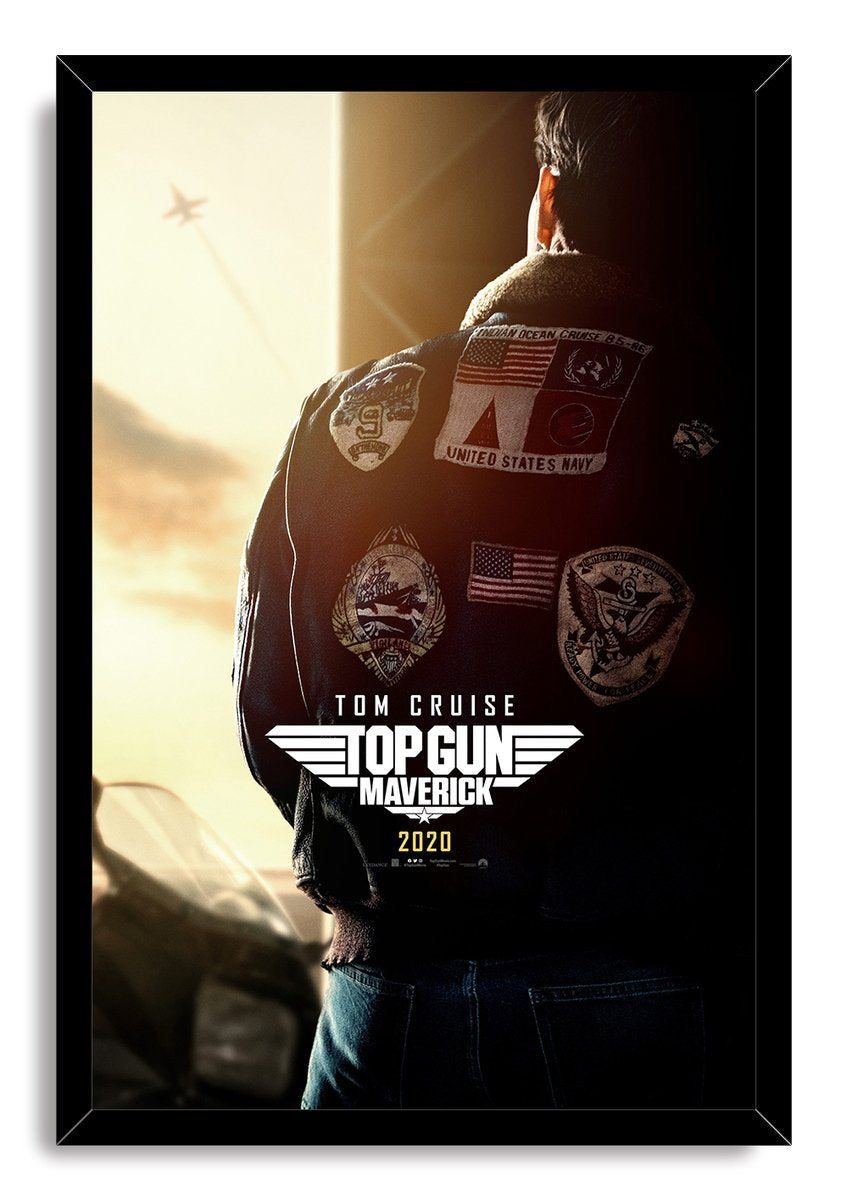 Top Gun Maverick framed wall art print presents Tom Cruise from behind in a patched bomber jacket, with sunset light and a distant aircraft.