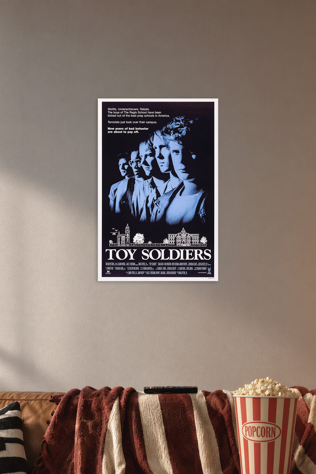 Toy Soldiers Movie Poster in a cozy movie room above a brown sofa with popcorn.