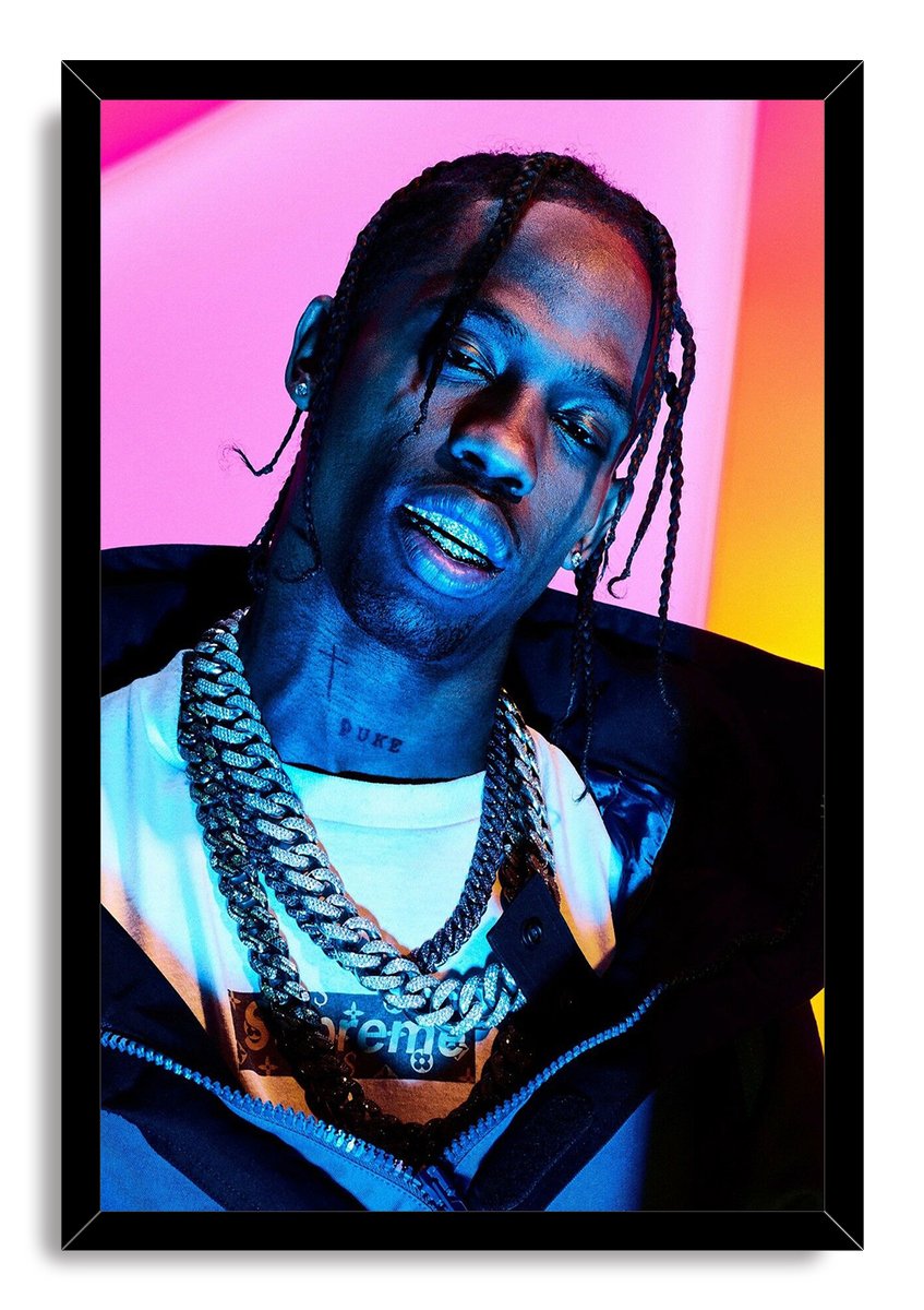 Travis Scott framed wall art print with a black border, depicting the rapper in braids and layered chains under vibrant blue, pink and orange light.