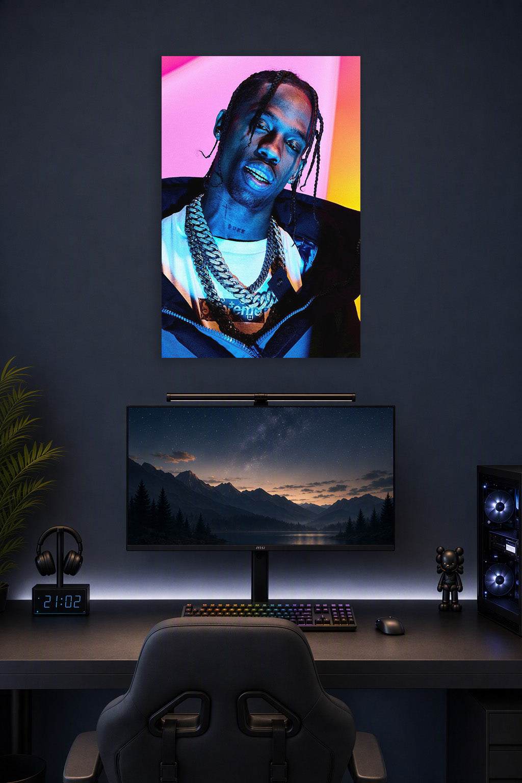 Travis Scott in a gaming desk setup above a monitor.