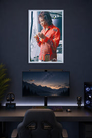 Trippie Redd in a gaming desk setup above a monitor.