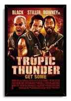 Tropic Thunder framed wall art print featuring three armed men with weapons, a blazing jungle backdrop, and bold cream title text.