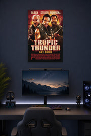 Tropic Thunder Movie Poster in a gaming desk setup above a monitor.