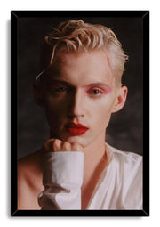 Troye Sivan framed wall art print in a black frame, portraying him with pink eye shadow, red lipstick and tousled blond hair.