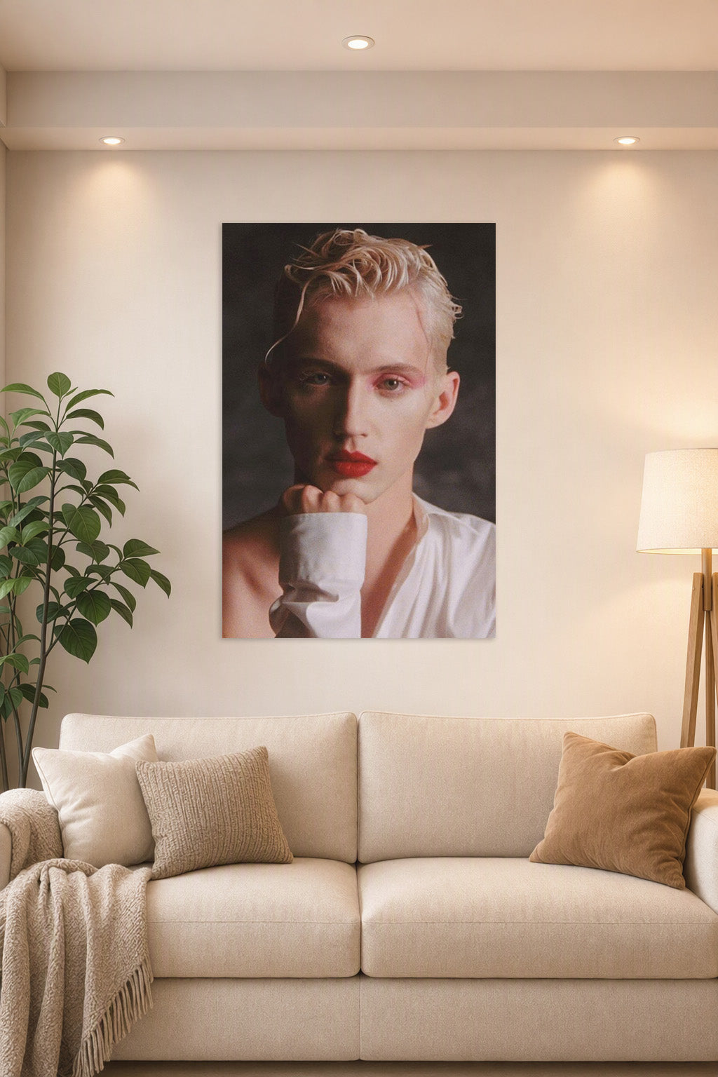 Troye Sivan in a bright living room above a beige sofa.