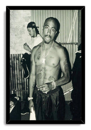 Tupac Shakur framed wall art print presents a black-and-white portrait of the shirtless rapper in a sleek black frame.