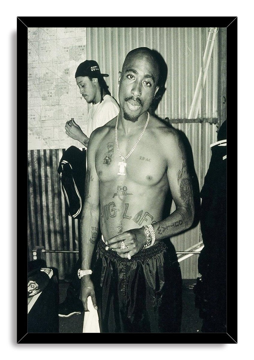 Tupac Shakur framed wall art print presents a black-and-white portrait of the shirtless rapper in a sleek black frame.