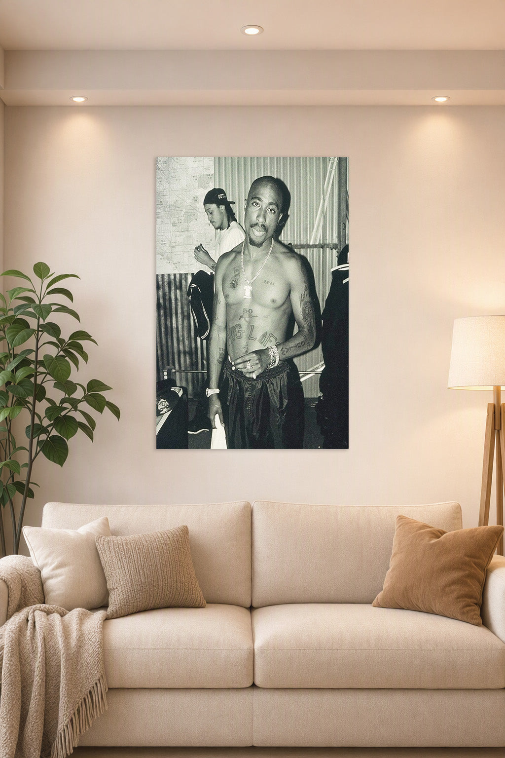 Tupac Shakur in a bright living room above a beige sofa.