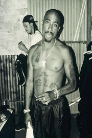Tupac Shakur poster features a black-and-white full-length portrait of the shirtless rapper wearing chains and watches.