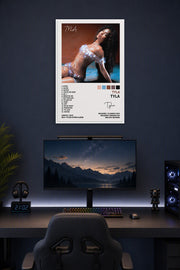 Tyla Tyla Poster Album Cover Posters for in a gaming desk setup above a monitor.