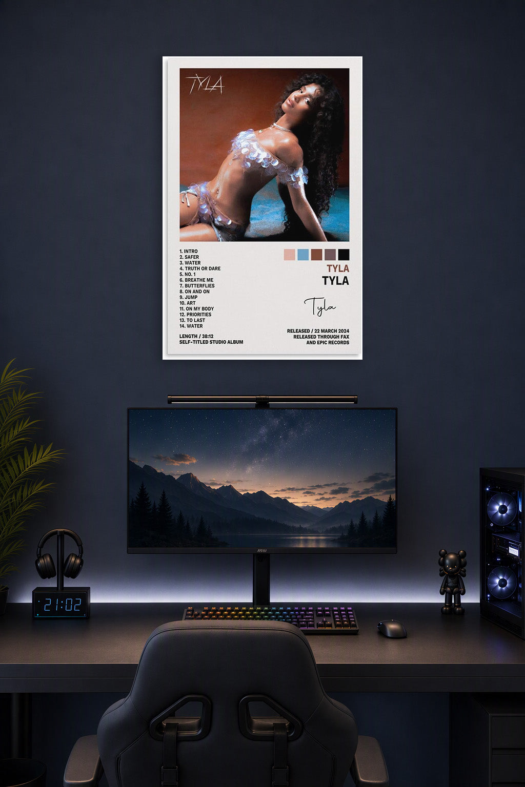 Tyla Tyla Poster Album Cover Posters for in a gaming desk setup above a monitor.