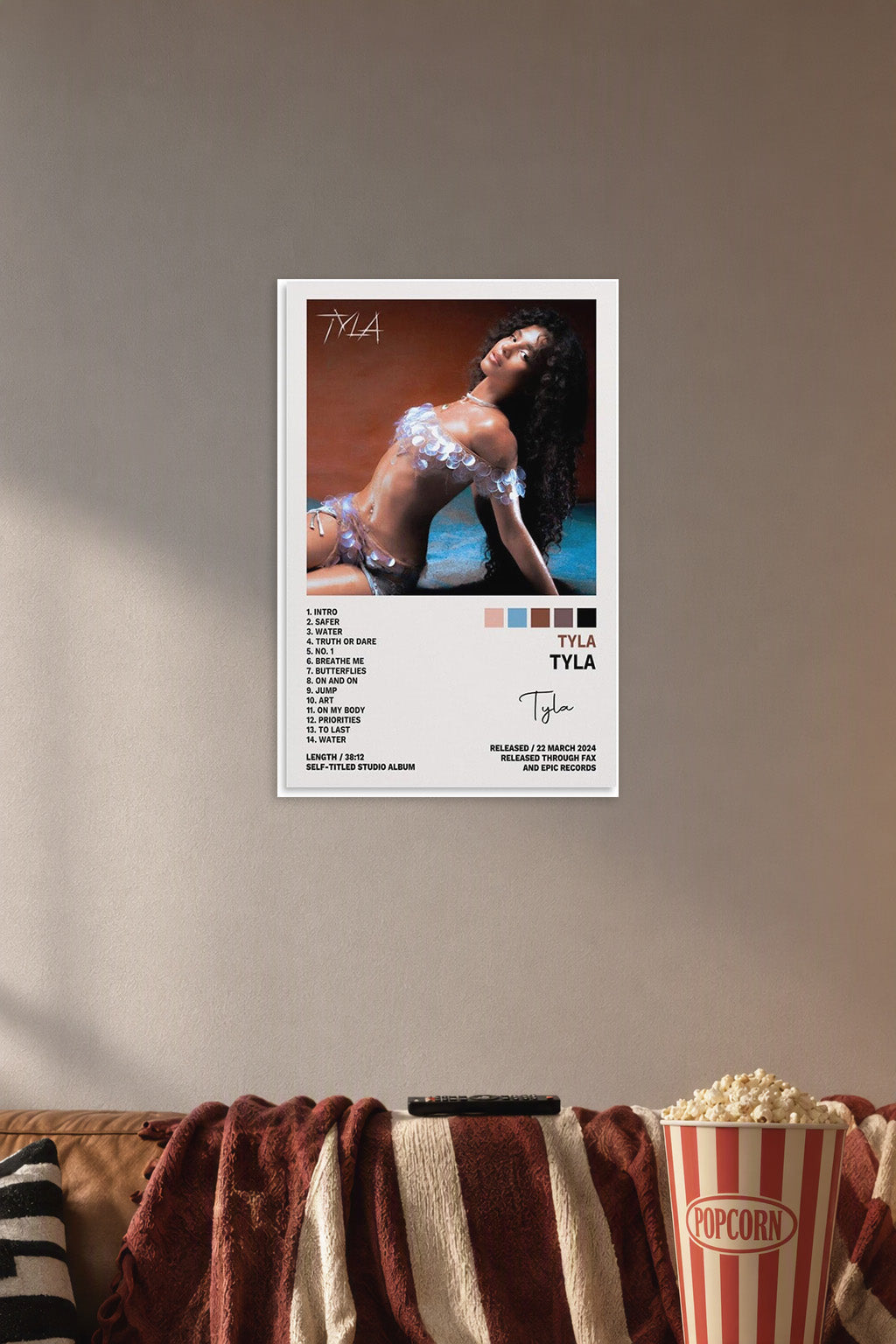 Tyla Tyla Poster Album Cover Posters for in a cozy movie room above a brown sofa with popcorn.
