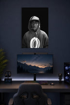 Tyler, The Creator in a gaming desk setup above a monitor.