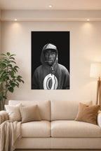 Tyler, The Creator in a bright living room above a beige sofa.