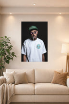 Tyler, The Creator in a bright living room above a beige sofa.