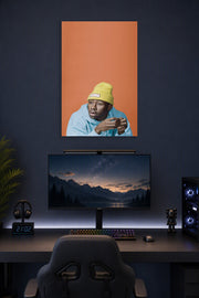 Tyler, The Creator in a gaming desk setup above a monitor.