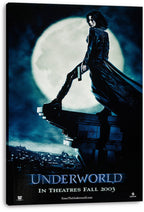 Underworld canvas wall art print features Selene with a handgun on a stone ledge, silhouetted against a moonlit blue city.