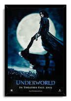 Framed Underworld wall art print portrays Selene in a flowing black coat and boots above a dark city beneath a full moon.
