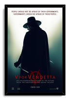 V for Vendetta framed wall art print depicts V in a Guy Fawkes mask, black cape and hat, holding daggers beneath red lettering.